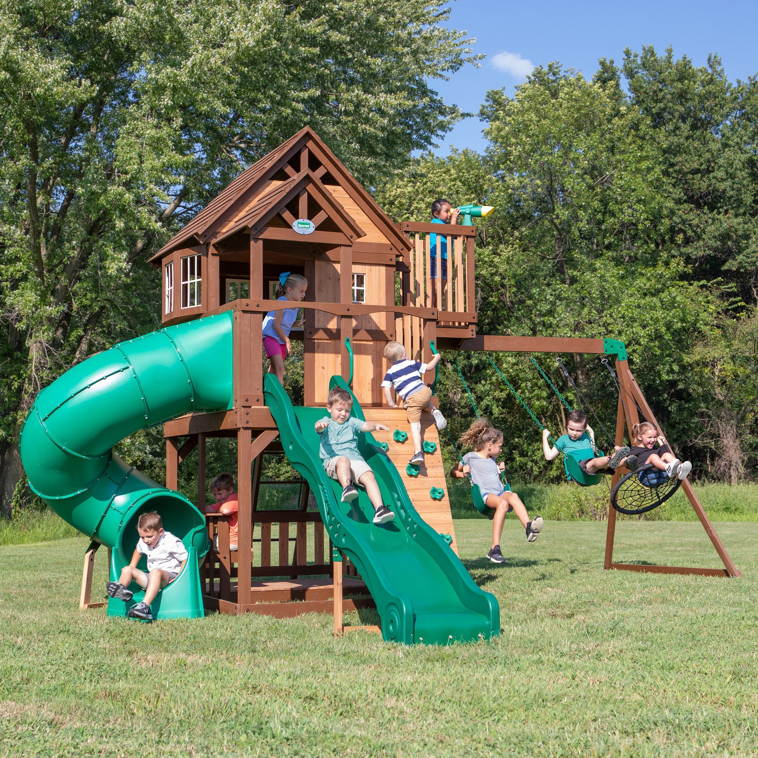 Kids swinging and playing on Eagle's Nest Elite backyard playset